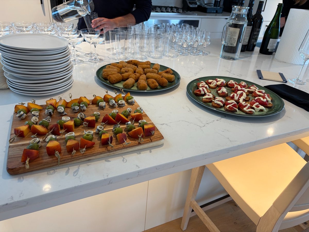 Skewers, croquettes and toasts laid out on a kitchen counter
