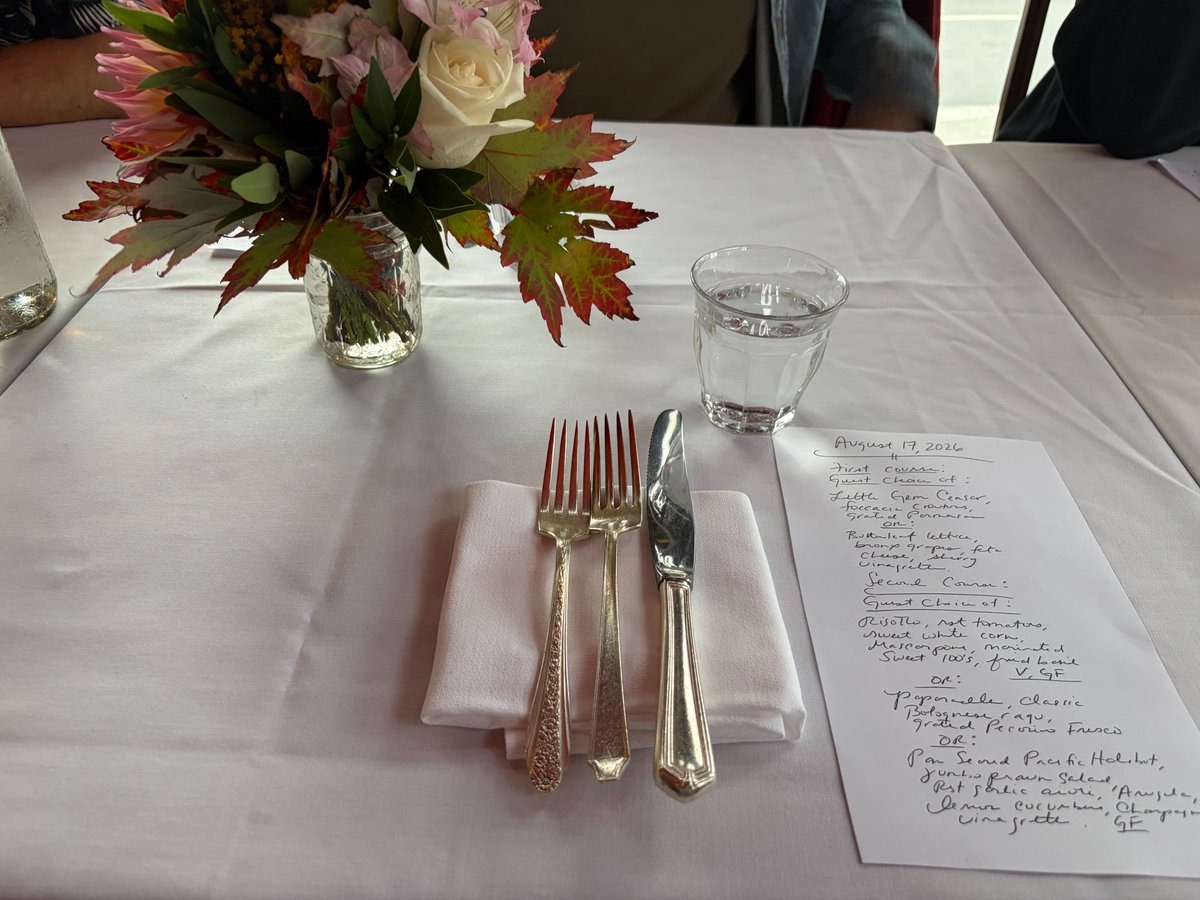 A place setting with flowers and a handwritten menu dated August 17, 2026